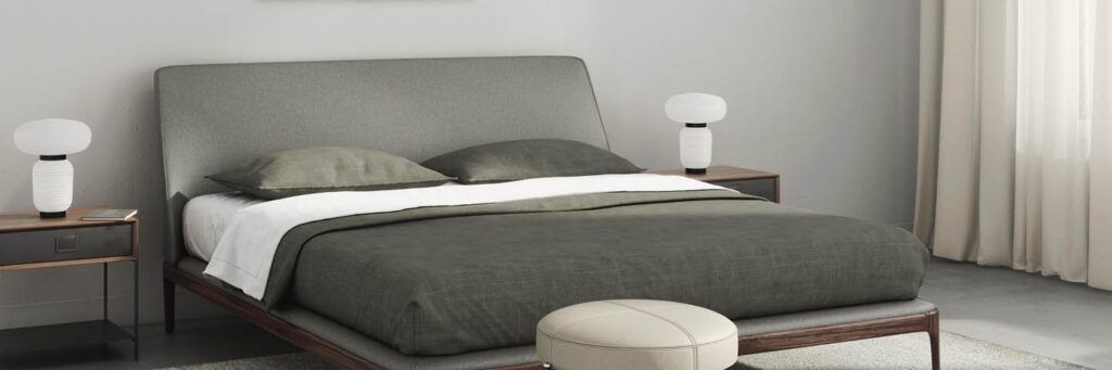 a minimalist modern bedroom in grey dove tone colours with a modern bed in the middle