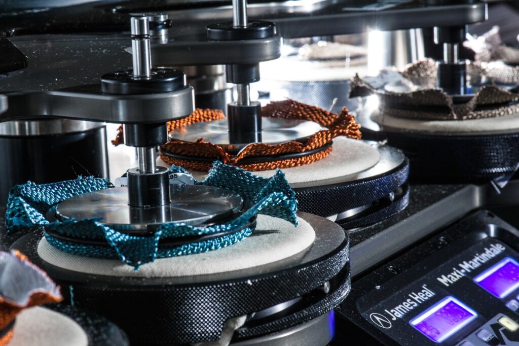closeup of an abrasion testing machine in action