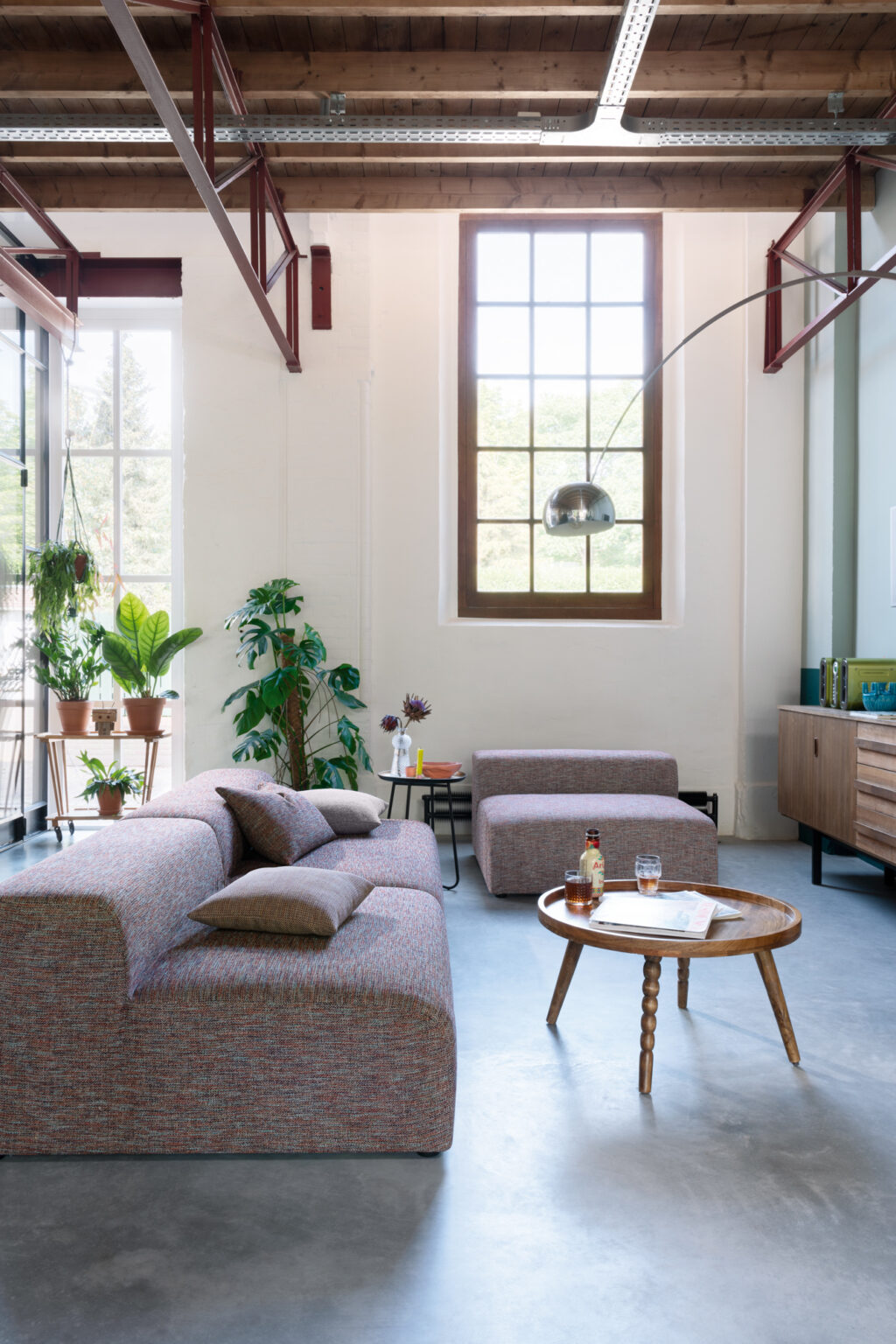 sideview of a living room thats been renovated from a farmhouse with stylish modern furniture creating a contemporary atmosphere