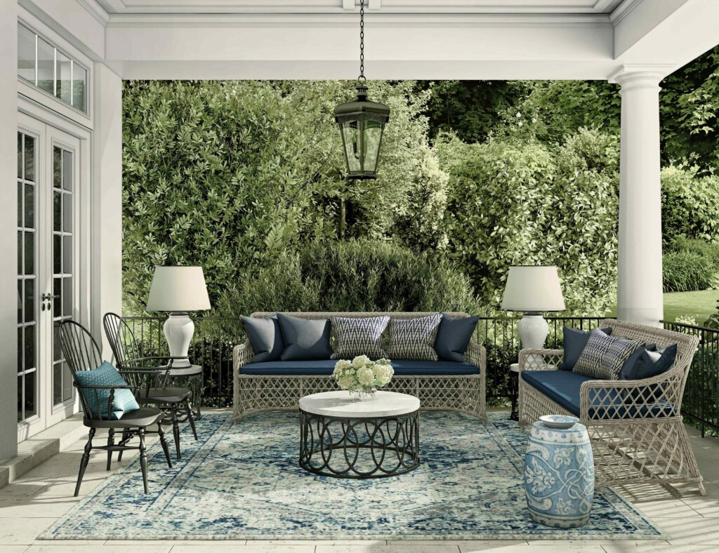 A spacious porch adorned with blue furniture and a large table, inviting relaxation and gatherings