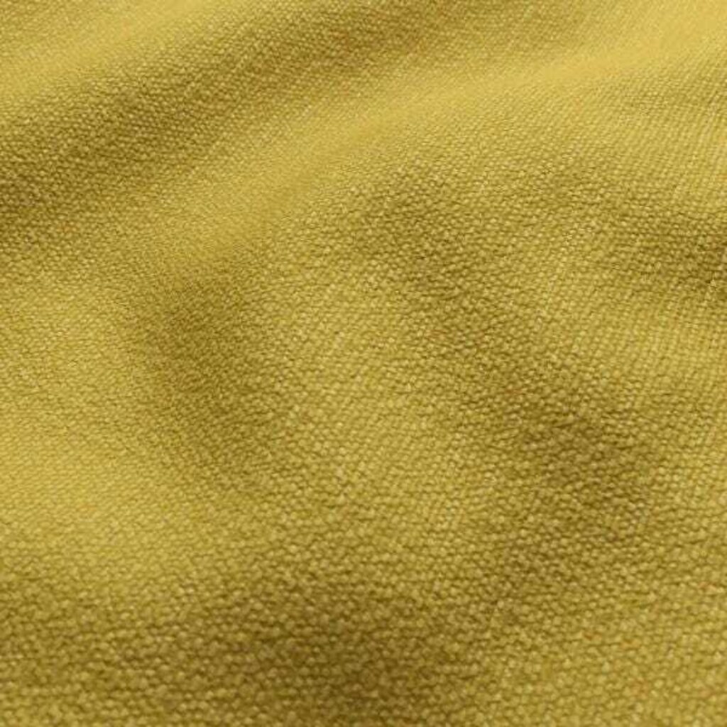 A detailed view of soft yellow fabric, highlighting its softness and deep color