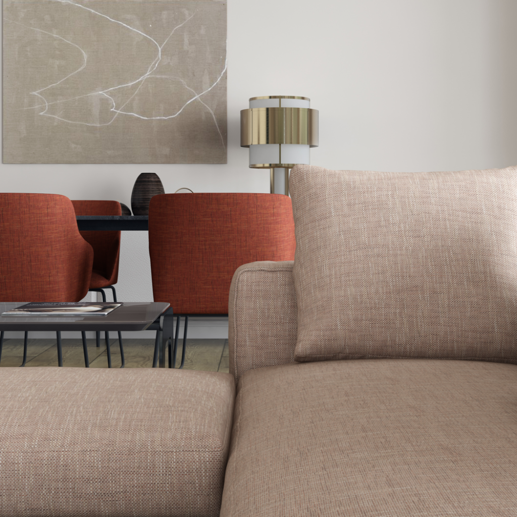 an elegant open plan living room with rust coloured dining chairs at a table and a soft beige sofa